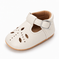 Baby Cut Out Mary Jane Shoes White variant image - White baby cut out Mary Jane shoes with visible leather texture, cut out upper, silver buckle and tan sole.