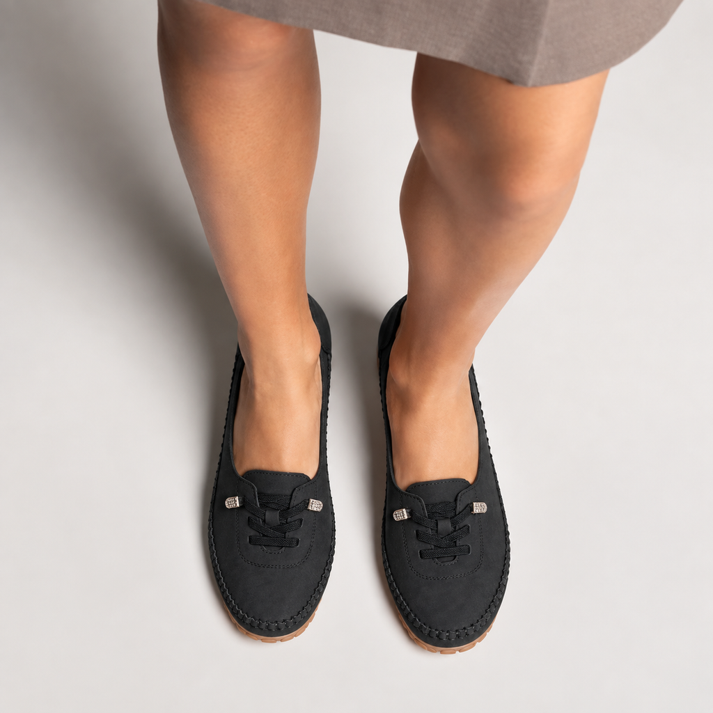 Black womens soft round toe comfort loafers worn with elegant outfit, comfortable everyday slip-on shoes