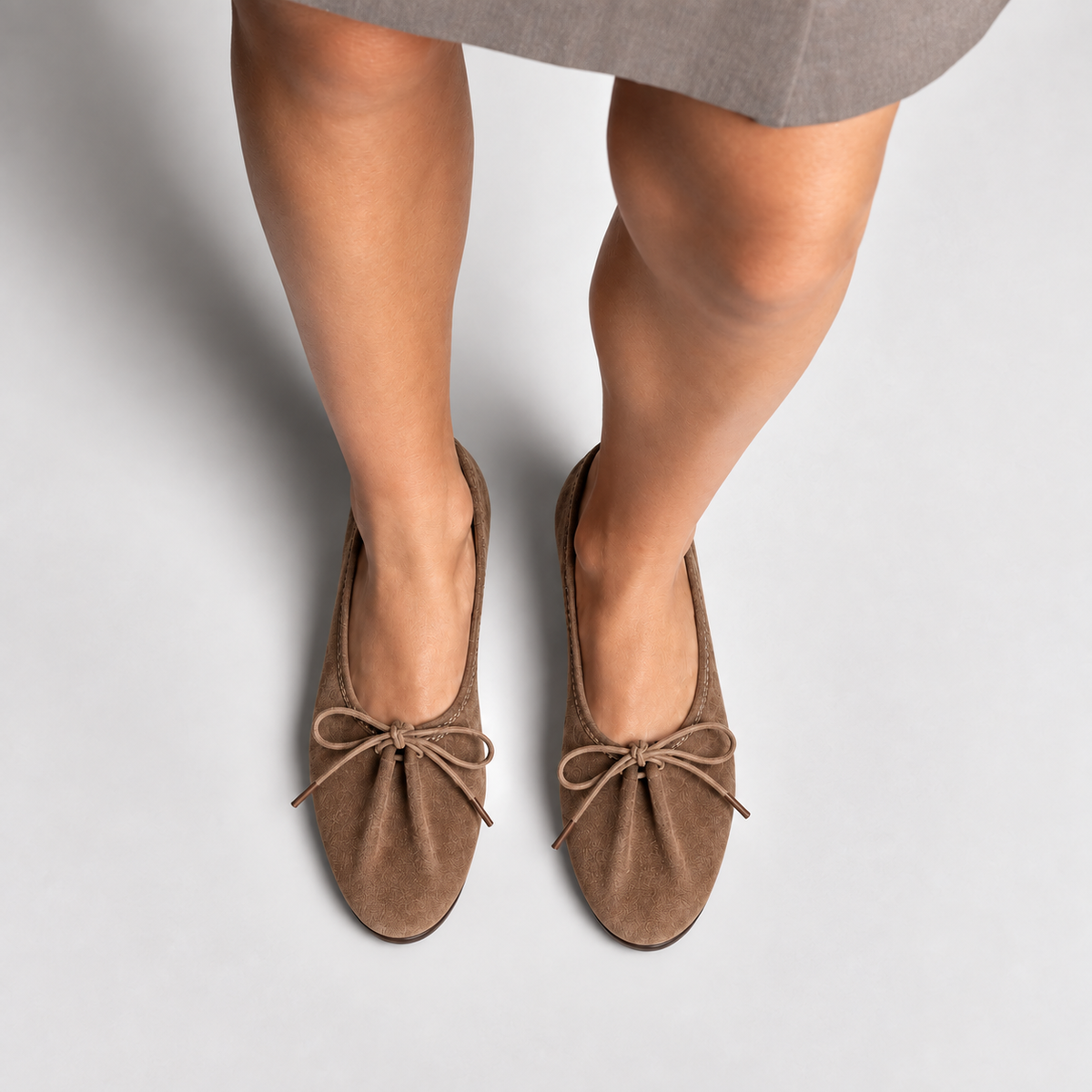 Brown suede lace up ballet flats worn by model, premium fashion styling photo with rounded almond toe