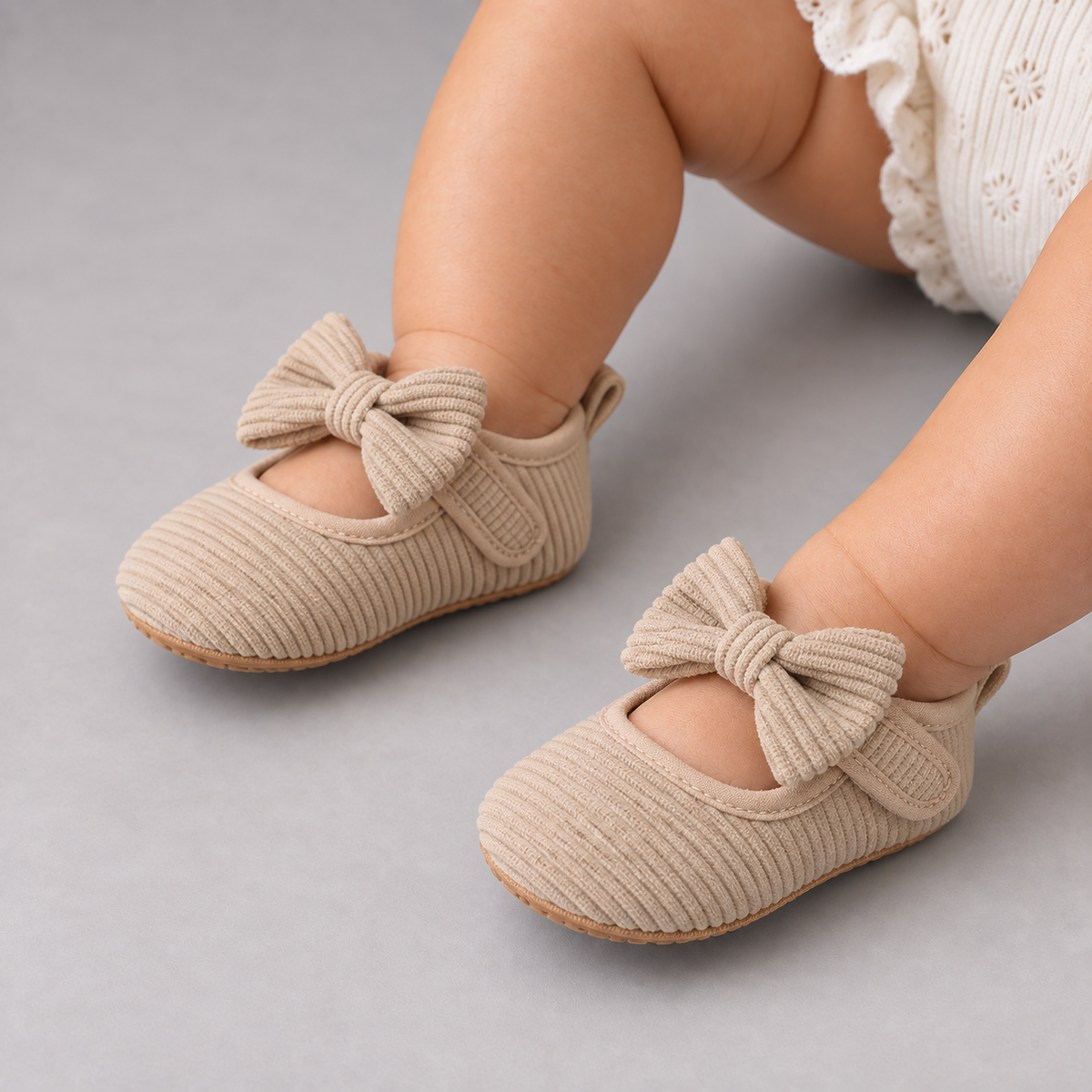 Baby girl wearing Beige Baby Bow Corduroy Mary Jane Shoes in premium studio photo