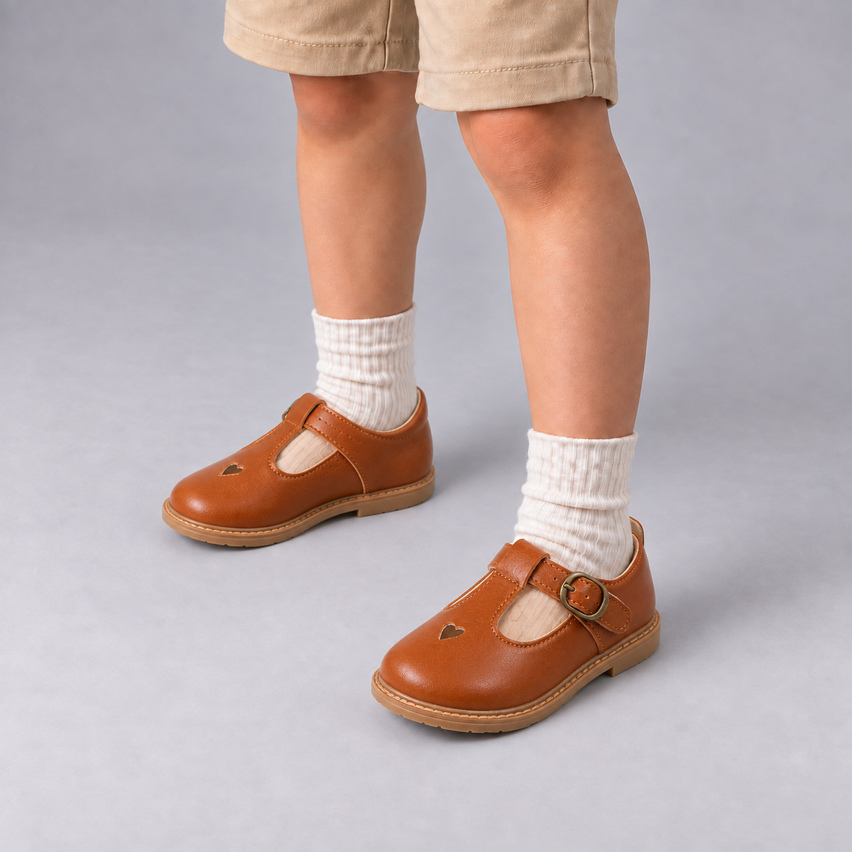 Boy wearing Brown Kids School Ballet Flats with cream socks in premium studio photo