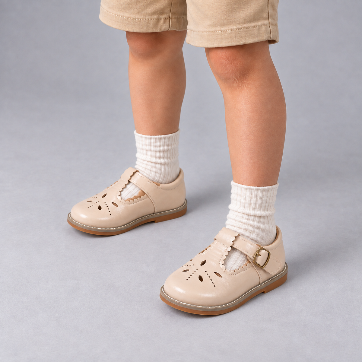 Boy wearing Beige Kids Mary Jane Breathable Ballet Flats with cream socks in premium studio photo