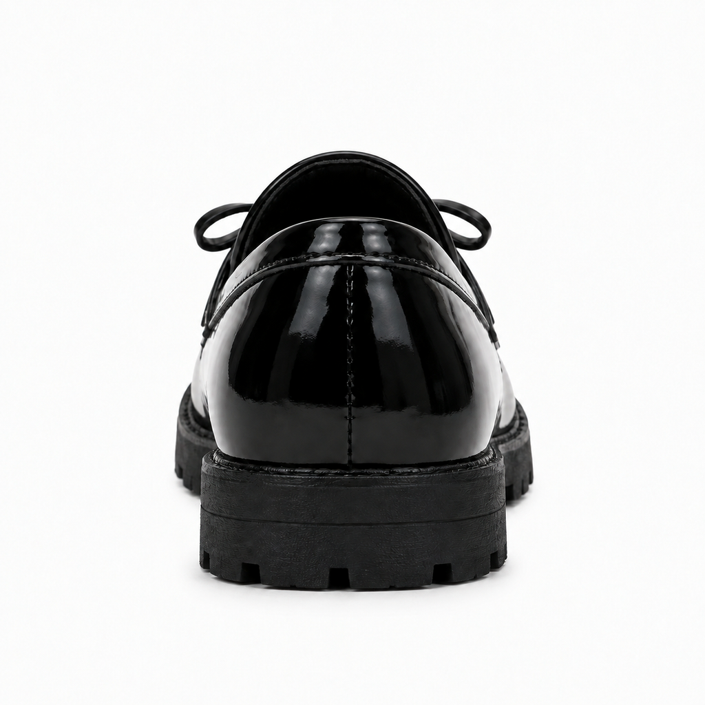 Kids Tassel Bow Loafers Black - rear view bow detail. Rear studio view of black glossy kids tassel bow loafers showing the heel, lug sole and subtle bow detail for a premium product gallery.