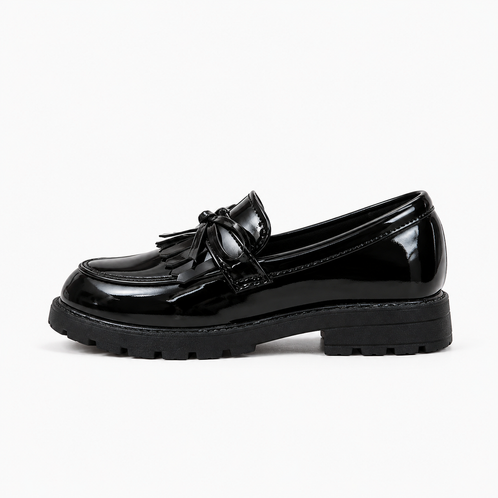 Kids Tassel Bow Loafers Black - side profile product photo. Premium side profile studio image of black glossy kids tassel bow loafers with chunky lug sole and polished patent finish.