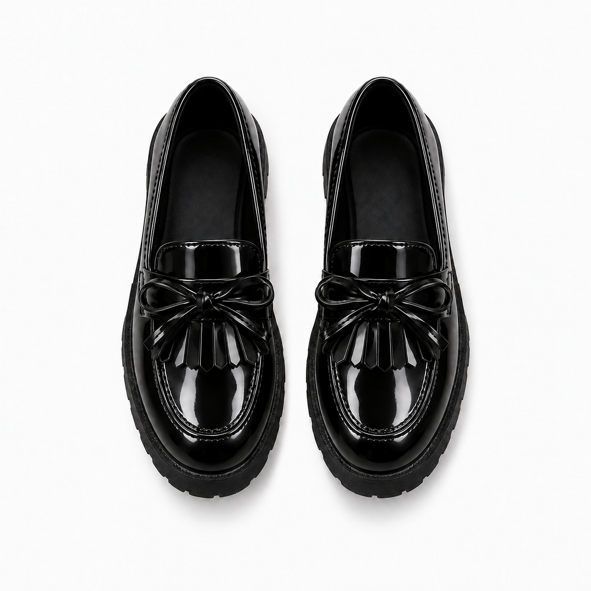 Kids Tassel Bow Loafers Black - top view with neat leather laces. Premium product photo of black glossy kids tassel bow loafers, top view, with neat leather laces and a clean lug sole.