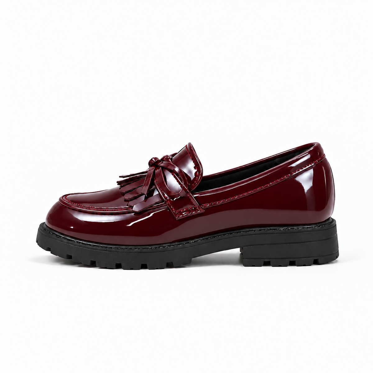 Kids Tassel Bow Loafers Burgundy - premium side profile product photo. Premium studio image of burgundy glossy kids tassel bow loafers with neat bow detail, polished patent finish and black lug sole.