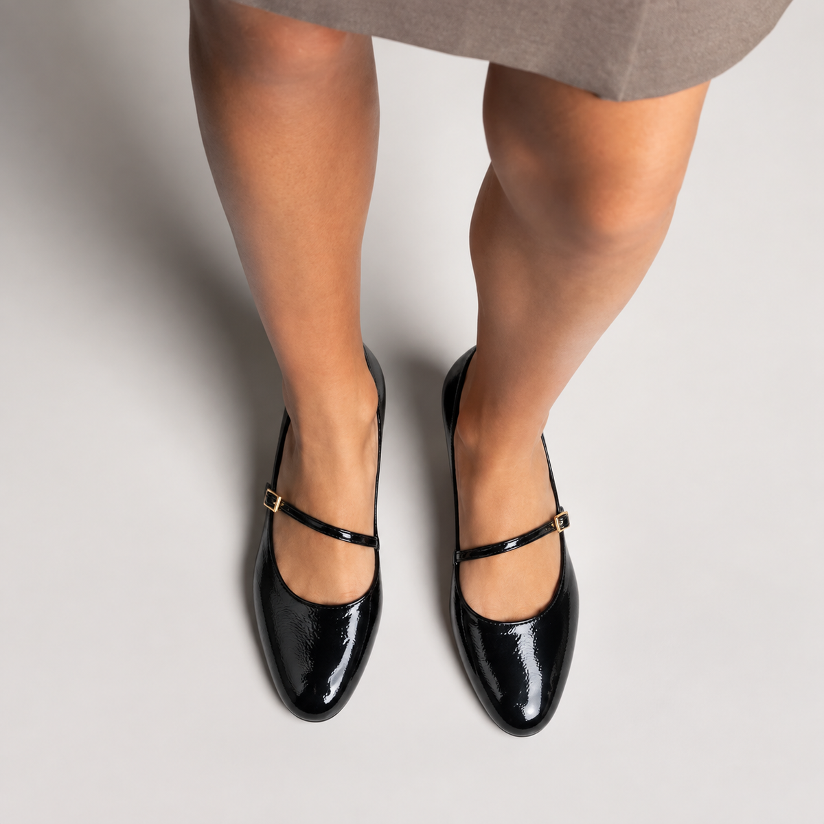 Black womens patent round toe ballet flats worn with elegant skirt styling